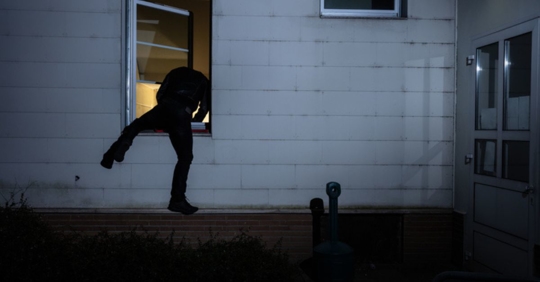 man going through window